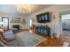 Living room with sectional sofa, hardwood floors, and fireplace at 404 Glenwood Ave, Burlington, NC 27215