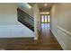 Light-filled entry hall with hardwood floors, staircase, and wainscoting at 433 Edison Rail Ln, Knightdale, NC 27545