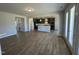 Open concept living room with kitchen and hardwood floors at 433 Edison Rail Ln, Knightdale, NC 27545