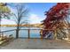 Lakefront deck with wooden railings and scenic lake views at 635 Sagamore Dr, Louisburg, NC 27549