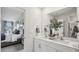 Clean bathroom with double vanity, large mirror, and view into bedroom at 6433 Alfalfa Ln, Wake Forest, NC 27587