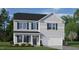 Two story home with gray siding, dark green shutters, and a two car garage at 6433 Alfalfa Ln, Wake Forest, NC 27587