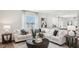 Spacious living room with large sectional sofa and round coffee table at 6433 Alfalfa Ln, Wake Forest, NC 27587