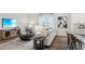 Open living room with sectional sofa and large TV at 6433 Alfalfa Ln, Wake Forest, NC 27587