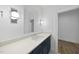 Modern bathroom with a navy vanity, white countertop, and stylish lighting at 2637 Trifle Ln, Wake Forest, NC 27587