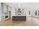 Modern kitchen with island, stainless steel appliances, and light cabinets at 2637 Trifle Ln, Wake Forest, NC 27587