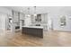Modern kitchen with island, stainless steel appliances, and light cabinets at 2637 Trifle Ln, Wake Forest, NC 27587