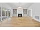 Bright living room features hardwood floors, fireplace, built-in shelving, and sliding glass doors to patio at 2637 Trifle Ln, Wake Forest, NC 27587