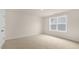 Bright bedroom featuring neutral walls and carpeted floors at 280 Umstead St, Sanford, NC 27330