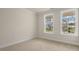 Spacious bedroom with neutral colored carpet and large windows at 280 Umstead St, Sanford, NC 27330