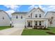 Two-story house with gray siding, stone accents, and a front porch at 280 Umstead St, Sanford, NC 27330