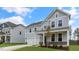 Two-story house with gray siding, stone accents, and a front porch at 280 Umstead St, Sanford, NC 27330