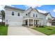 Two-story house with gray siding, stone accents, and a front porch at 280 Umstead St, Sanford, NC 27330