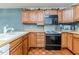 View of kitchen with wood cabinets and appliances at 370 Lakestone Estates Ests, Pittsboro, NC 27312