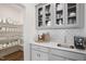 Butlers pantry with glass-front cabinets, quartz countertops and espresso machine at 8740 Maxine St # 7 Selma, Willow Springs, NC 27592