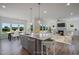 Open concept kitchen with island, stainless steel appliances, and view to backyard at 8740 Maxine St # 7 Selma, Willow Springs, NC 27592