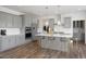 Modern kitchen with gray cabinets, quartz countertops, and large island at 8740 Maxine St # 7 Selma, Willow Springs, NC 27592