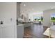 Modern kitchen with gray cabinets, an island, and access to the living area at 8740 Maxine St # 7 Selma, Willow Springs, NC 27592