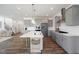 Modern kitchen with gray cabinets, quartz countertops, and large island at 8740 Maxine St # 7 Selma, Willow Springs, NC 27592