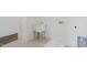Laundry room with utility sink and built-in shelving at 8740 Maxine St # 7 Selma, Willow Springs, NC 27592