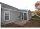 Rear exterior view showing gray siding and sliding glass doors to sunroom at 11331 Involute Pl # 100, Raleigh, NC 27617