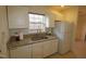 Galley kitchen features granite countertops, white cabinets, and stainless steel dishwasher at 11331 Involute Pl # 100, Raleigh, NC 27617