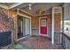 Brick patio with red door access and sliding glass door at 1204 Breedlove Rd, Nashville, NC 27856