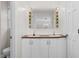 Double vanity bathroom with a lighted mirror and cabinetry at 1204 Breedlove Rd, Nashville, NC 27856
