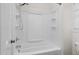 Clean bathroom with a shower/tub combo and built-in shelving at 1204 Breedlove Rd, Nashville, NC 27856