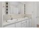 Double vanity bathroom with lighted mirror and ample storage at 1204 Breedlove Rd, Nashville, NC 27856