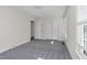 Bedroom with grey carpet, double door closet and window at 1204 Breedlove Rd, Nashville, NC 27856