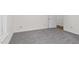 Simple bedroom with grey carpet and an open door to another room at 1204 Breedlove Rd, Nashville, NC 27856