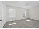 Bright bedroom featuring grey carpet and two large windows at 1204 Breedlove Rd, Nashville, NC 27856