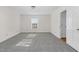 Bright bedroom with grey carpet, window, and access to a hallway at 1204 Breedlove Rd, Nashville, NC 27856