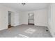 Bright bedroom with grey carpet, window, and en-suite bathroom access at 1204 Breedlove Rd, Nashville, NC 27856