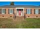 Brick ranch house with red front door and stairs at 1204 Breedlove Rd, Nashville, NC 27856