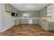 Bright eat-in kitchen with light green cabinets and wood-look flooring at 1204 Breedlove Rd, Nashville, NC 27856