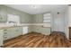 Kitchen with light green cabinets and wood flooring at 1204 Breedlove Rd, Nashville, NC 27856