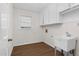 Laundry room with utility sink, cabinets and vinyl flooring at 1204 Breedlove Rd, Nashville, NC 27856