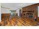 Spacious living area showcasing a brick fireplace and hardwood floors at 1204 Breedlove Rd, Nashville, NC 27856