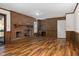 Living room featuring a brick fireplace and wood paneled walls at 1204 Breedlove Rd, Nashville, NC 27856