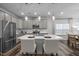 Modern kitchen with island, stainless steel appliances, and white cabinets at 1216 White Flint Cir, Durham, NC 27703