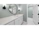 Modern bathroom with a white vanity, round mirror and green walls at 154 Leatherwood Ln, Chapel Hill, NC 27517