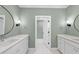 Elegant bathroom with double vanities, green walls, and a stylish floor at 154 Leatherwood Ln, Chapel Hill, NC 27517
