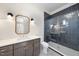 Modern bathroom with dark vanity, white sink, and frameless shower at 154 Leatherwood Ln, Chapel Hill, NC 27517