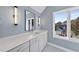 Modern bathroom with gray vanity, large window and blue walls at 154 Leatherwood Ln, Chapel Hill, NC 27517