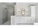 Modern bathroom featuring a walk-in shower, vanity with storage, and gold accents at 154 Leatherwood Ln, Chapel Hill, NC 27517