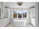 Elegant bathroom boasting a large soaking tub and an expansive window at 154 Leatherwood Ln, Chapel Hill, NC 27517