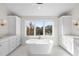 Luxurious bathroom with a freestanding tub, ample cabinetry, and a view at 154 Leatherwood Ln, Chapel Hill, NC 27517