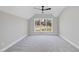 Spacious bedroom with gray carpet and a large window with nature views at 154 Leatherwood Ln, Chapel Hill, NC 27517